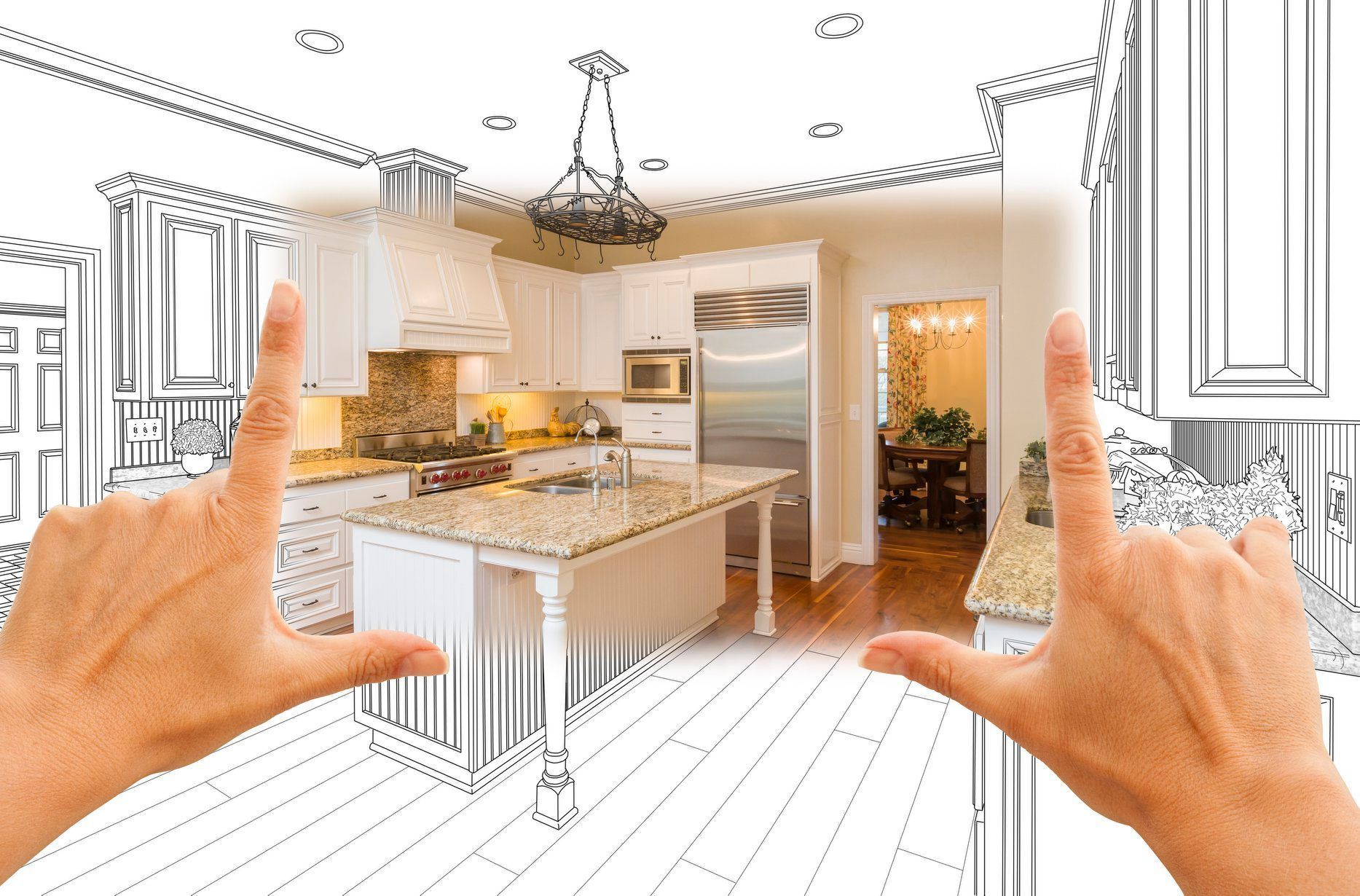 A person is framing a drawing of a kitchen with their hands.