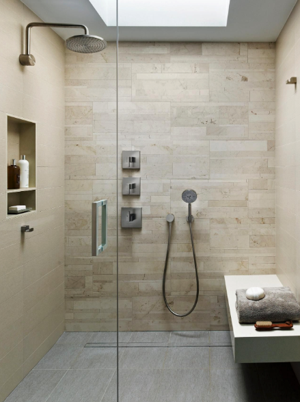A bathroom with a walk in shower and a bench