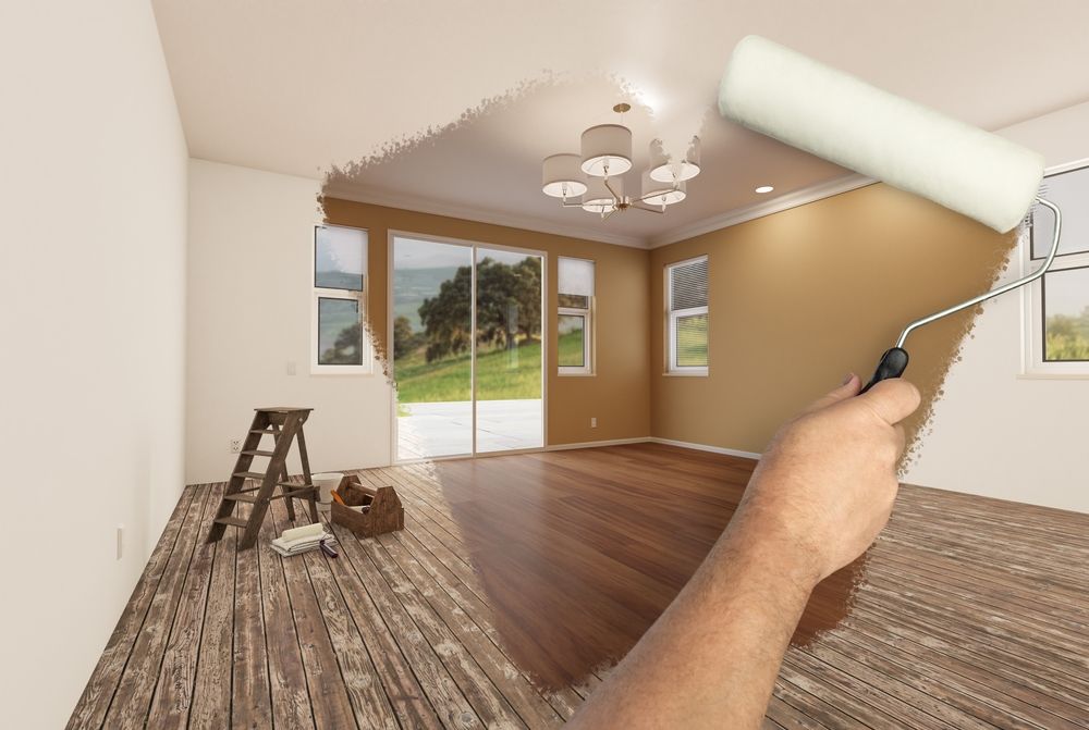 A person is painting a room with a paint roller.