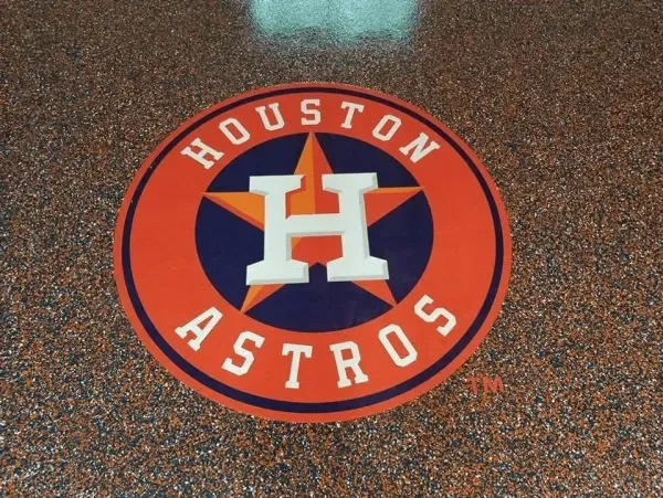 Houston Astros logo on speckled orange floor.