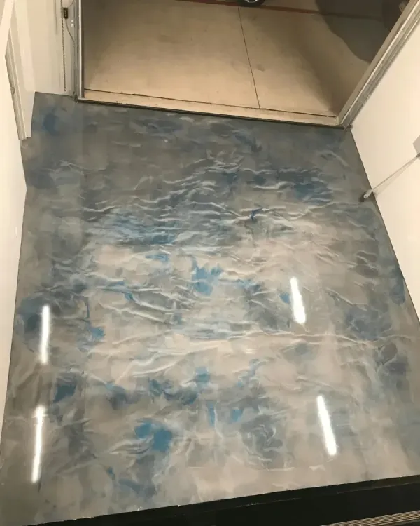 Metallic epoxy garage floor with shades of blue and silver.
