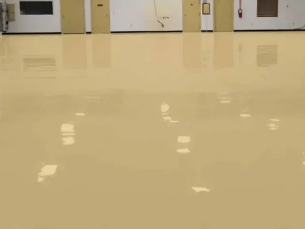 Shiny, beige floor in an empty room, reflecting the doors and ceiling lights.