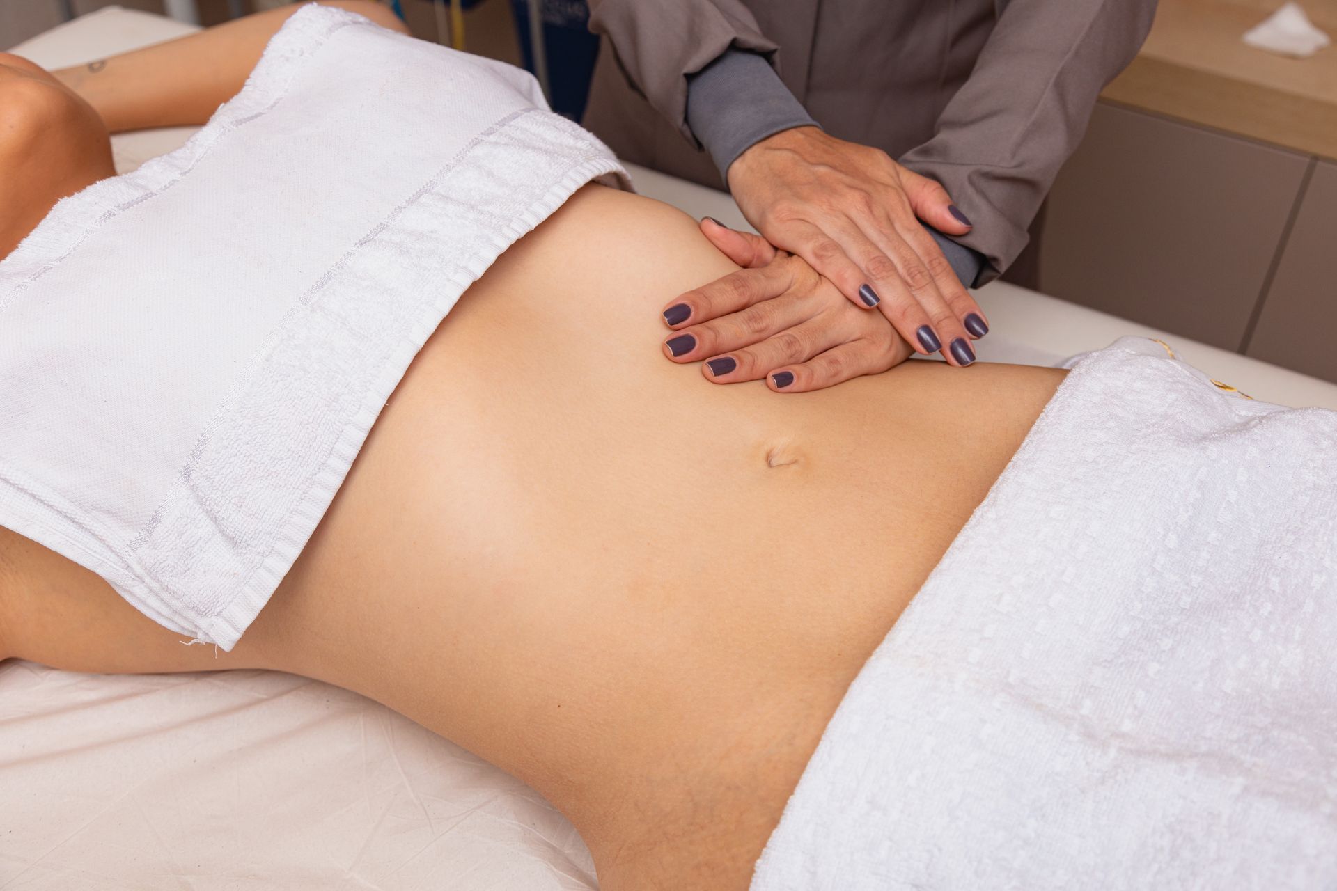 A woman is getting a massage on her stomach in a spa.
