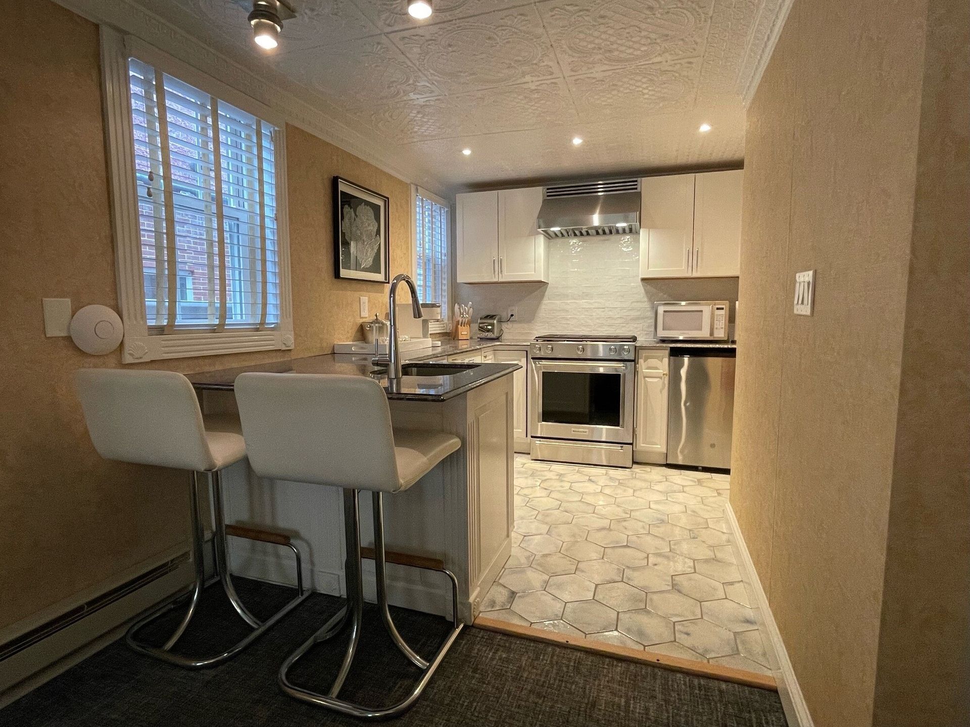 A kitchen with stainless steel appliances and white cabinets
