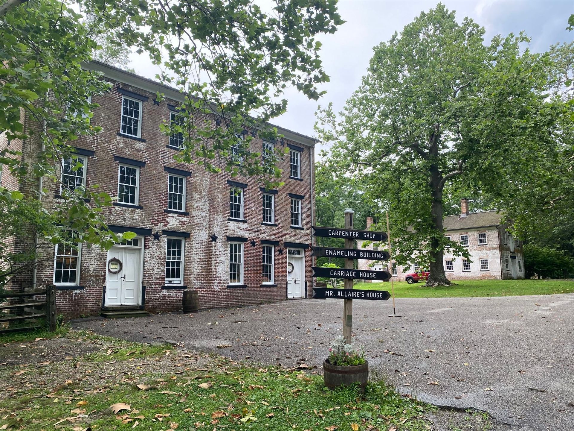 A large brick building with a sign in front of it.