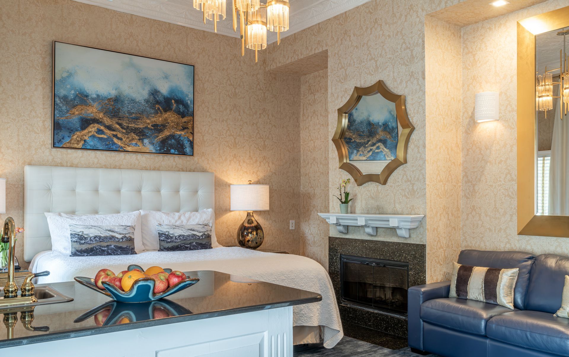 A hotel room with a bed , couch , and mirror.