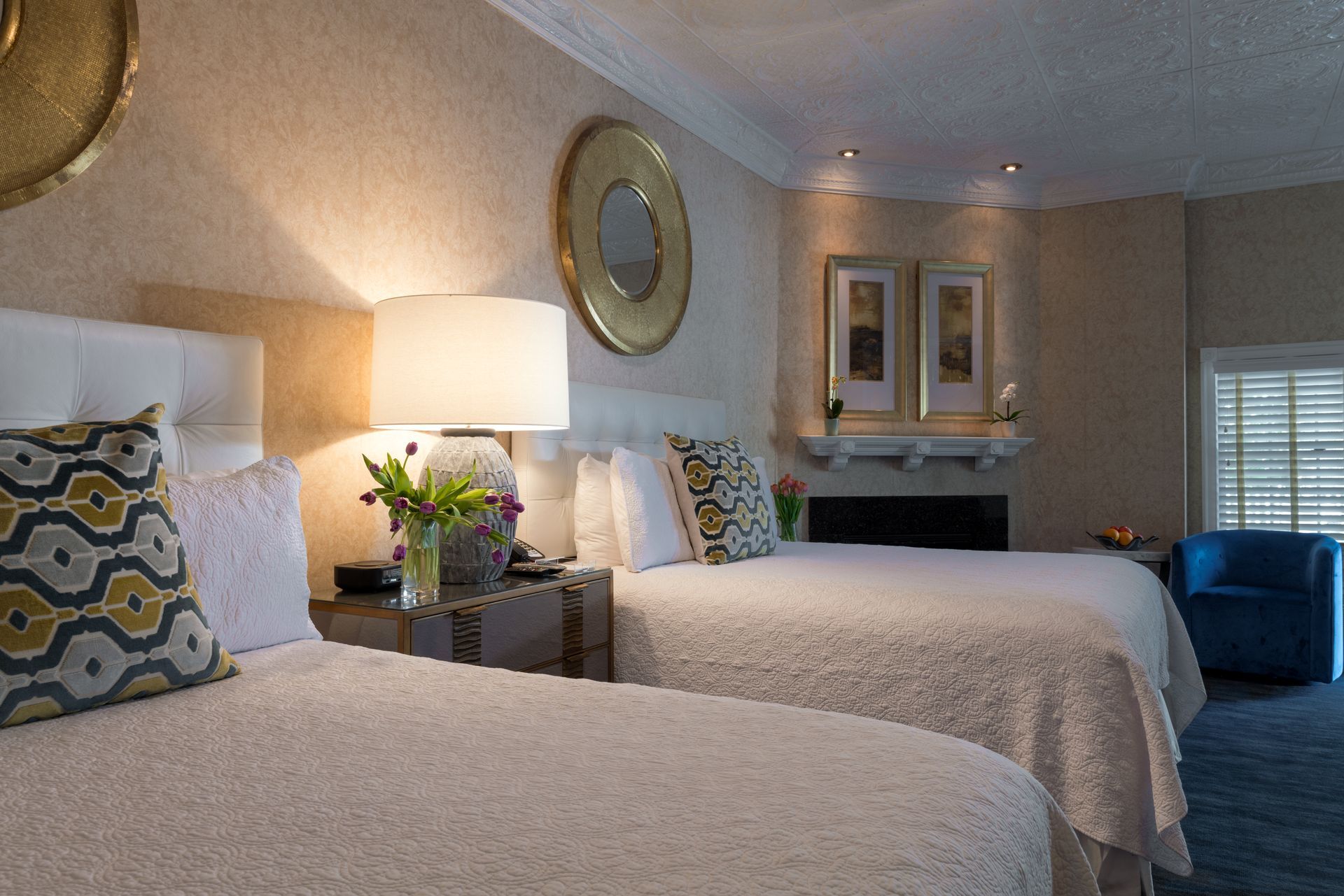 A hotel room with two beds and a fireplace