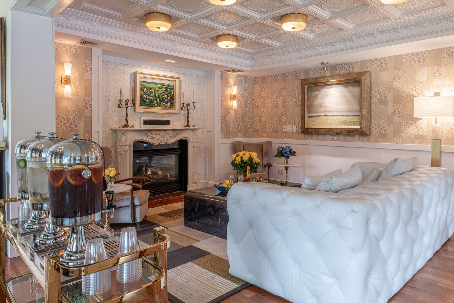 A living room with a white couch and a fireplace.