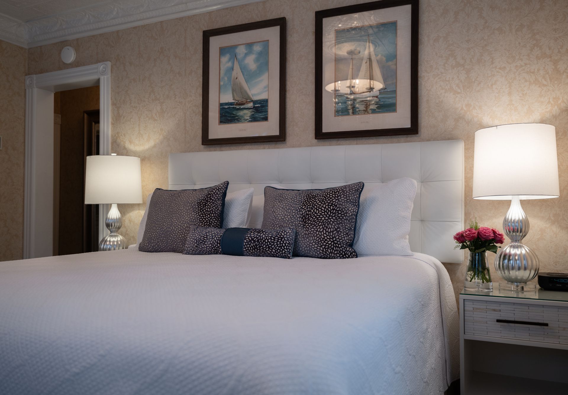 A hotel room with a king size bed and two lamps