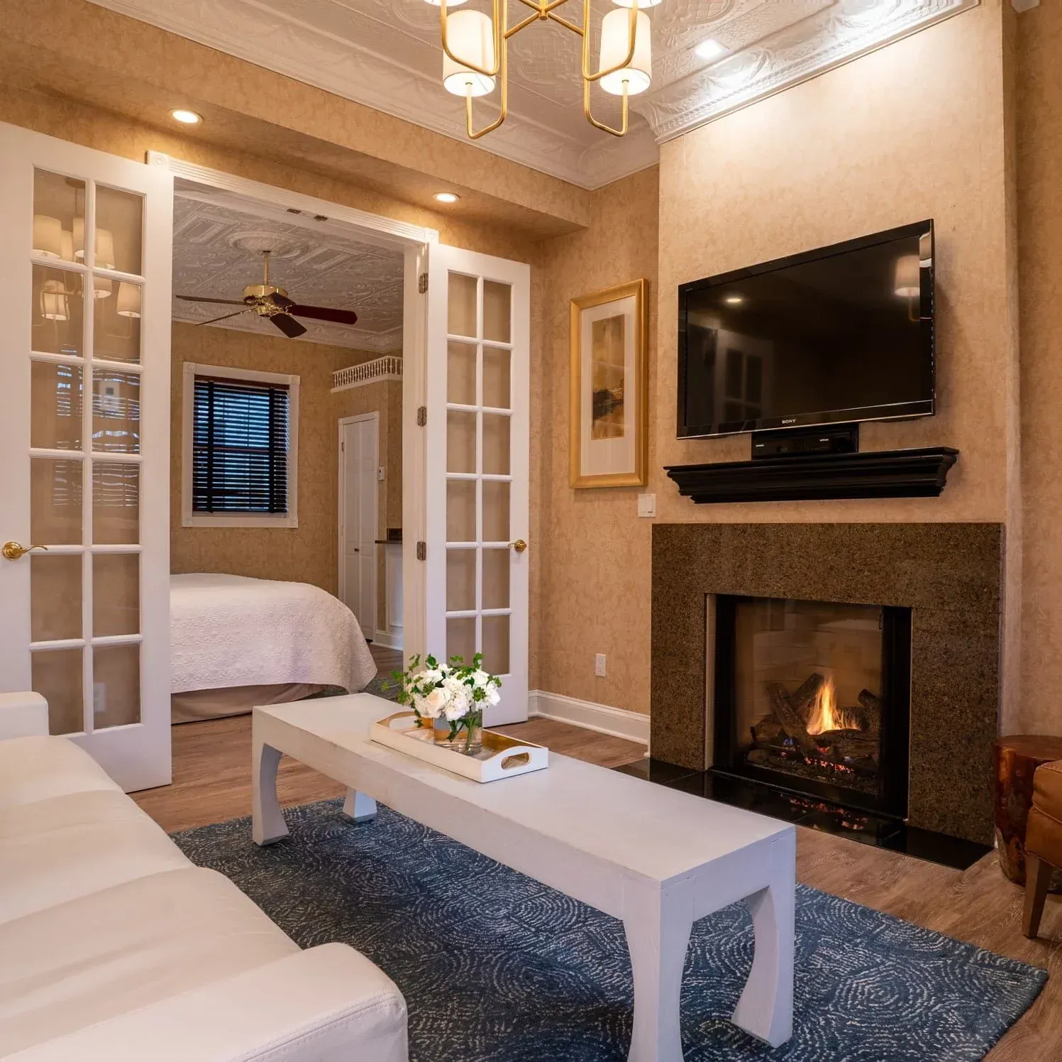 A living room with a fireplace and a flat screen tv