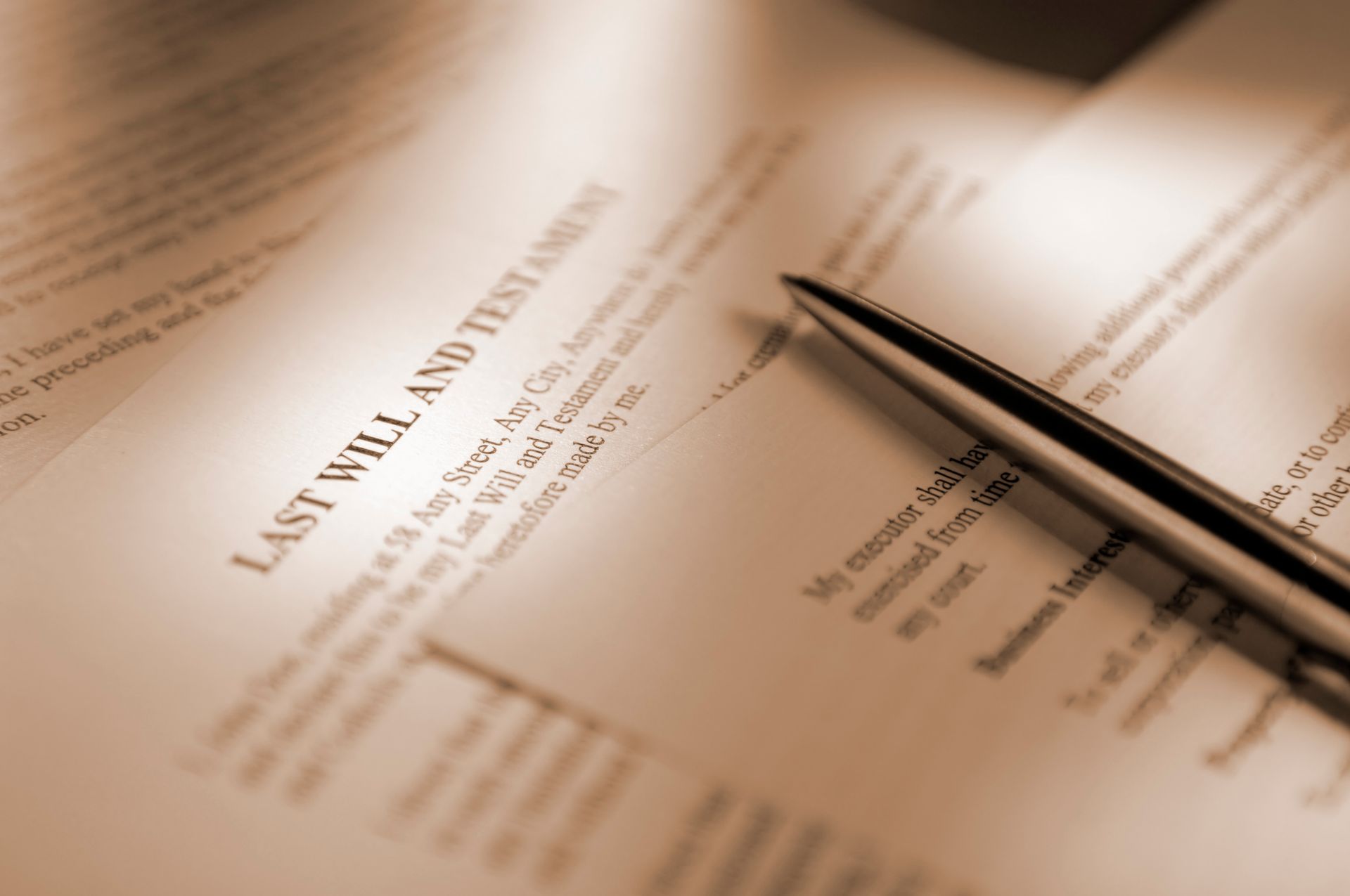 Close-up of last will and testament document with pen resting on paper Close-up of last will and testament document with pen resting on paper