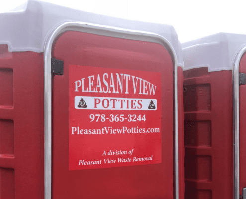 A red portable toilet with pleasant view potties written on it