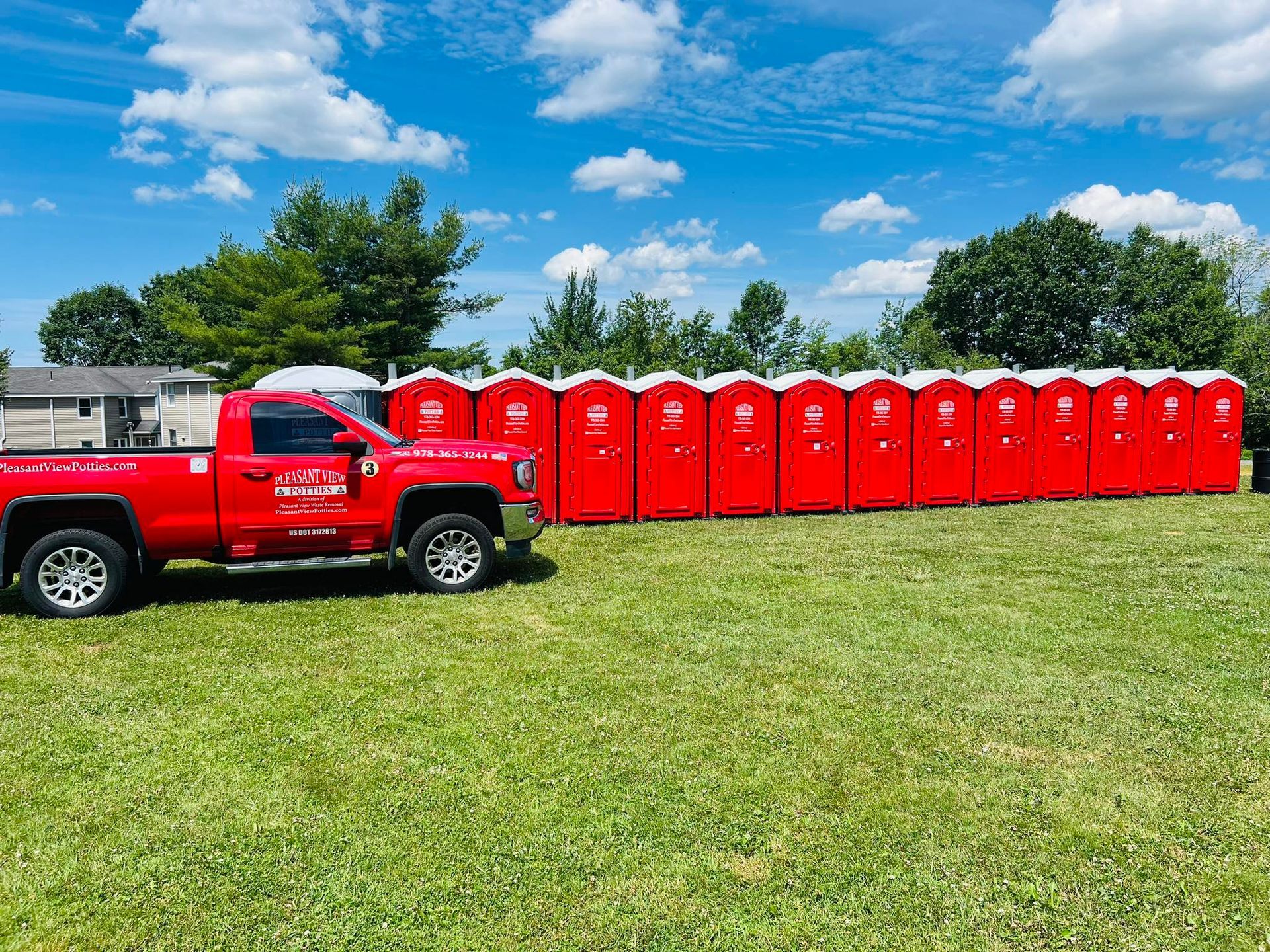 A portable toilet is sitting on the side of the road next to a construction site.