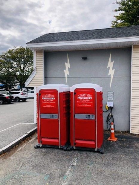 A couple of red portable toilets. A couple of red portable toilets.