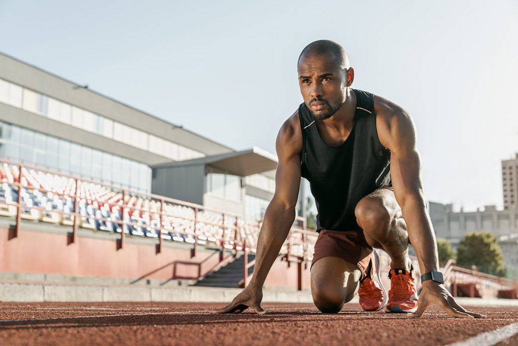 A man is getting ready to run on a track.