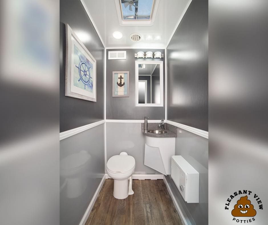 A small bathroom with a toilet , sink and mirror.