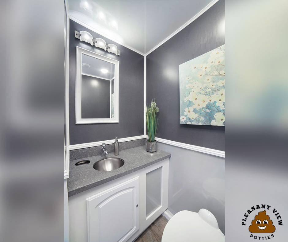 A bathroom with a sink , toilet and mirror.