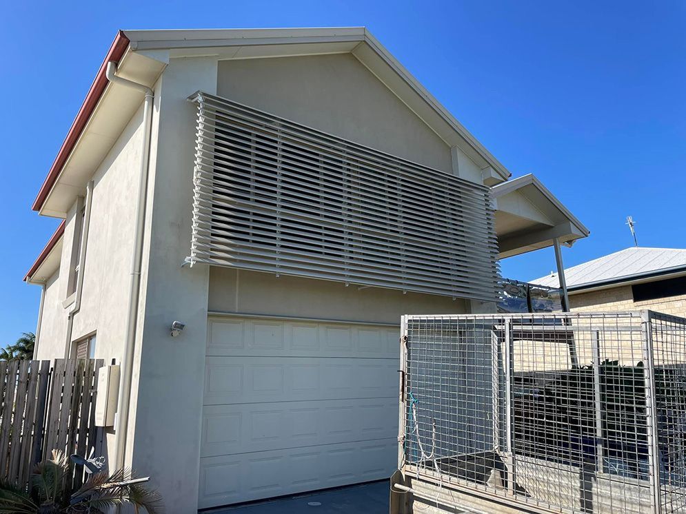 A White House With A Garage And A Fence In Front Of It — Affordable Screens & Blinds in Thabeban, QLD