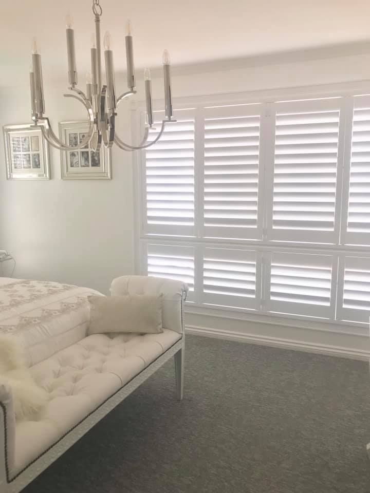 A Bedroom With A Bed And A Ceiling Fan — Affordable Screens & Blinds in Thabeban, QLD