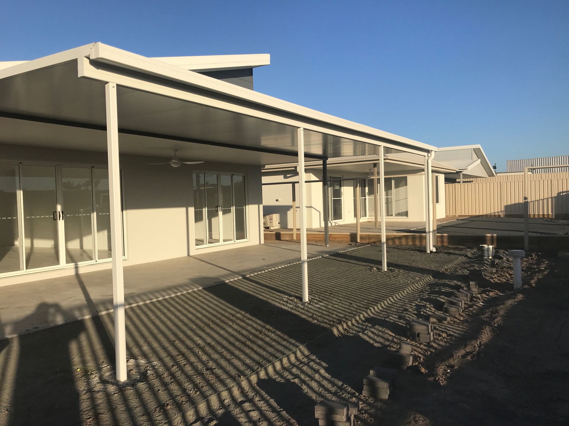 A Brick House With A Covered Patio And A Pizza Oven — Affordable Screens & Blinds in Thabeban, QLD