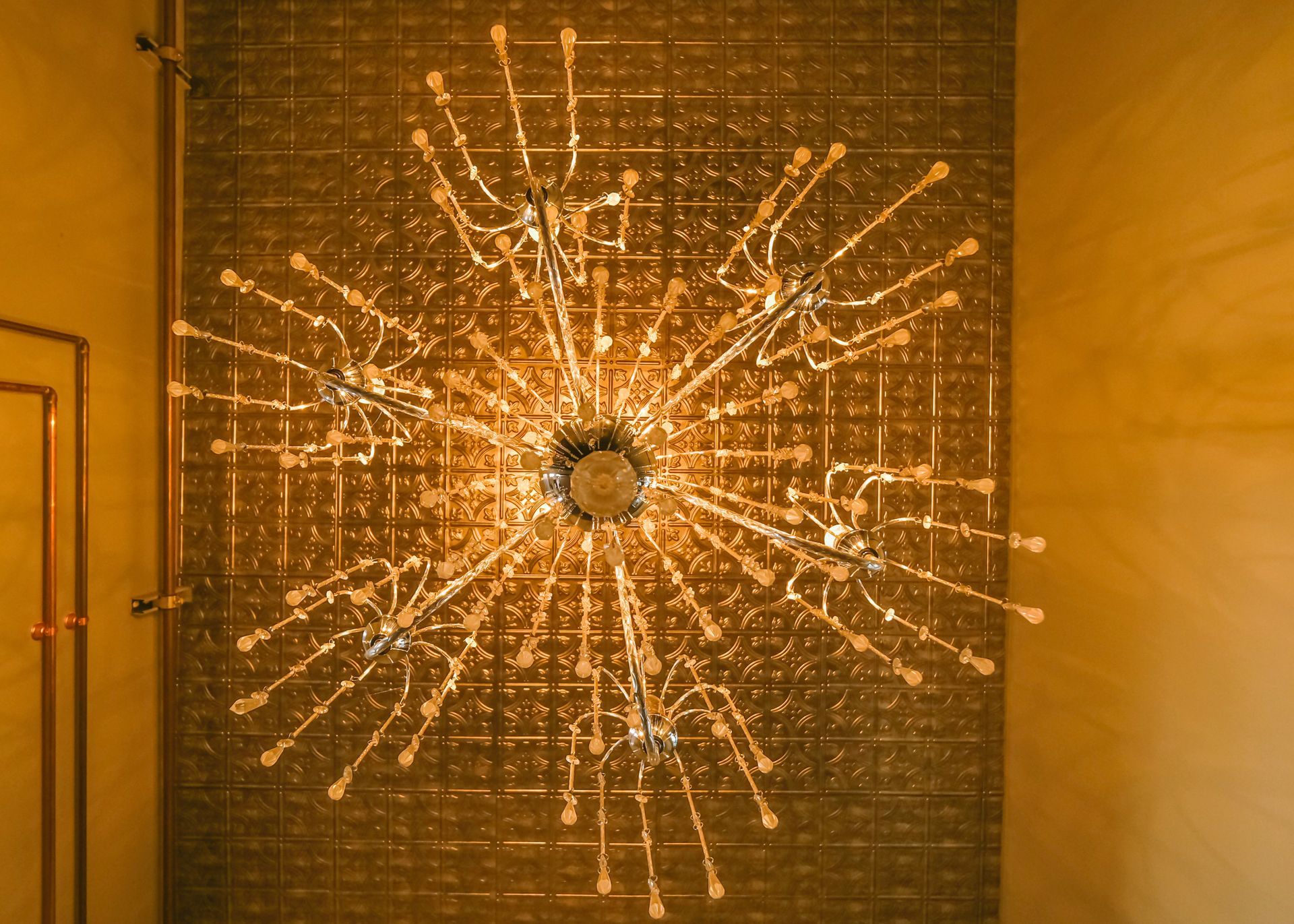 A chandelier is hanging from the ceiling in a room