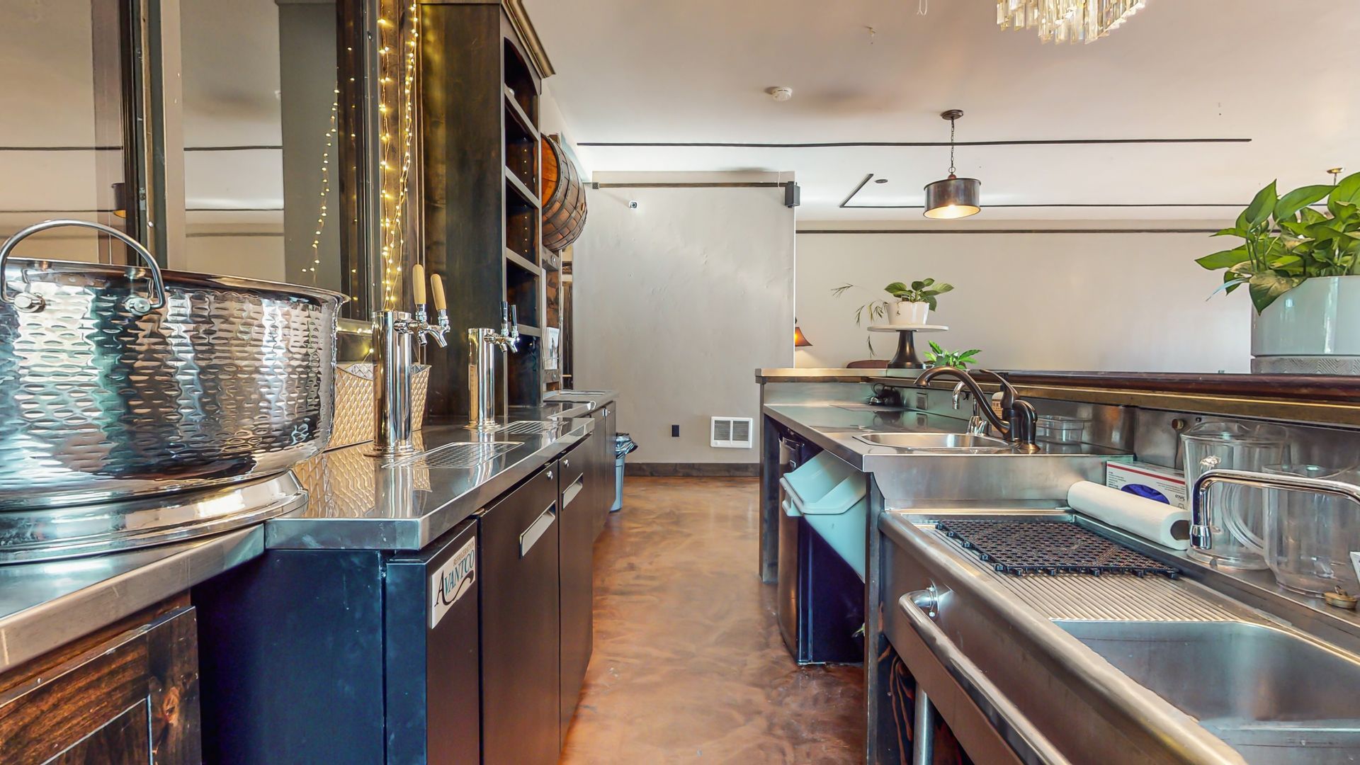 A kitchen with a lot of stainless steel appliances and a sink.