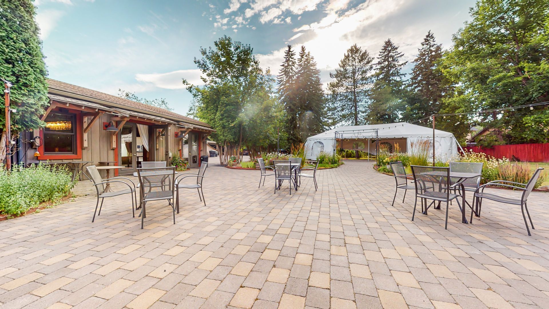 A patio with tables and chairs in front of a building