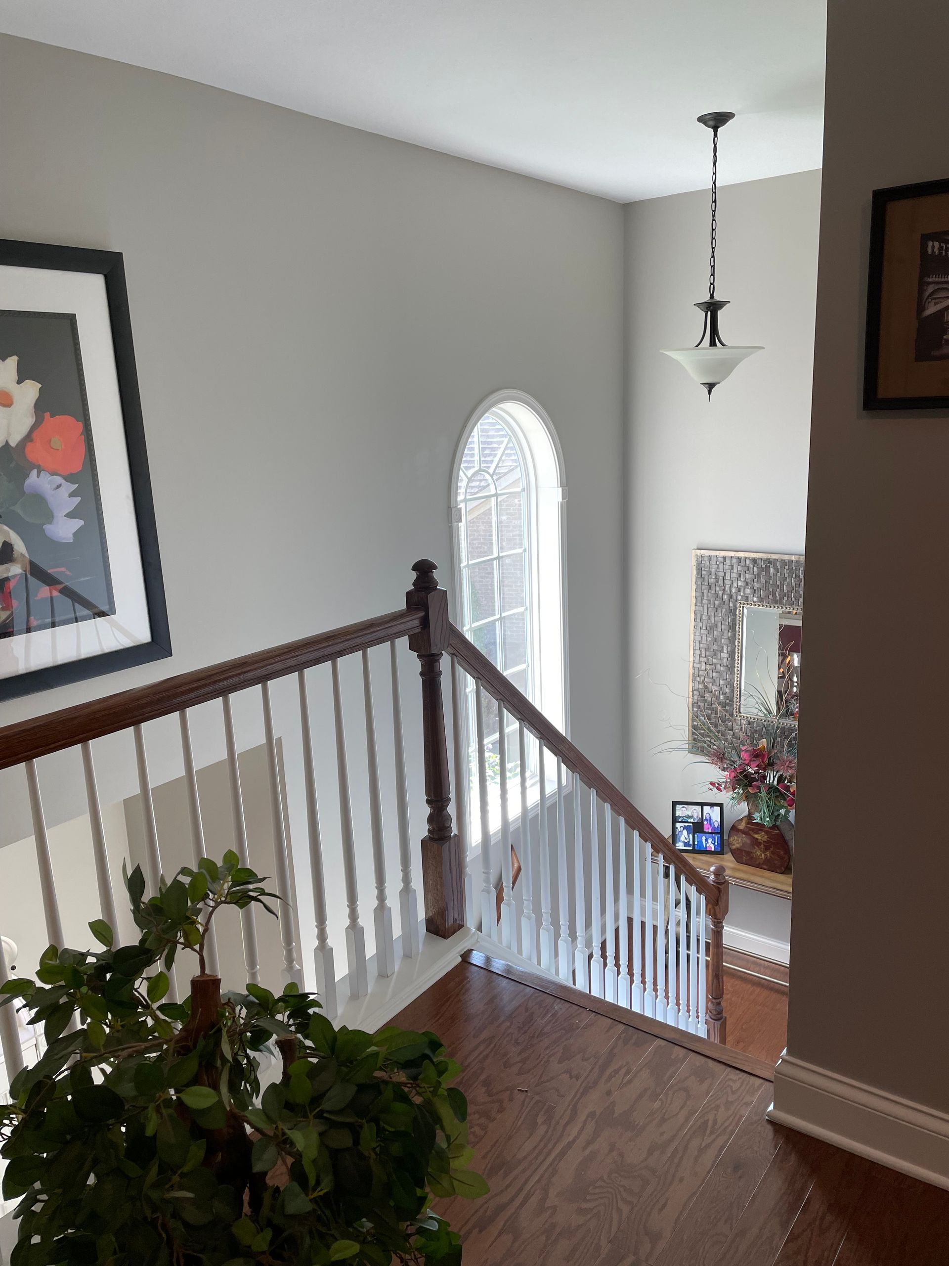 A staircase with a picture on the wall above it
