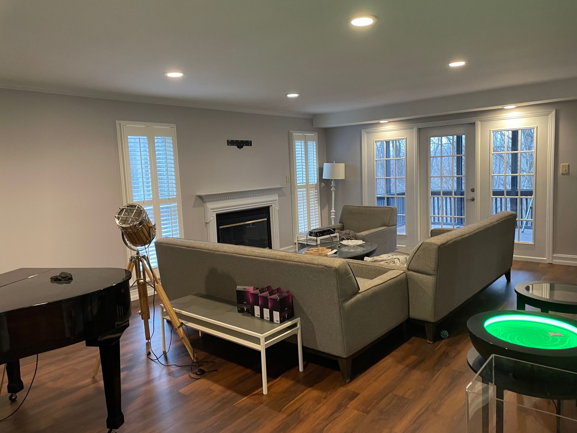 A living room with a piano , couch , and fireplace.