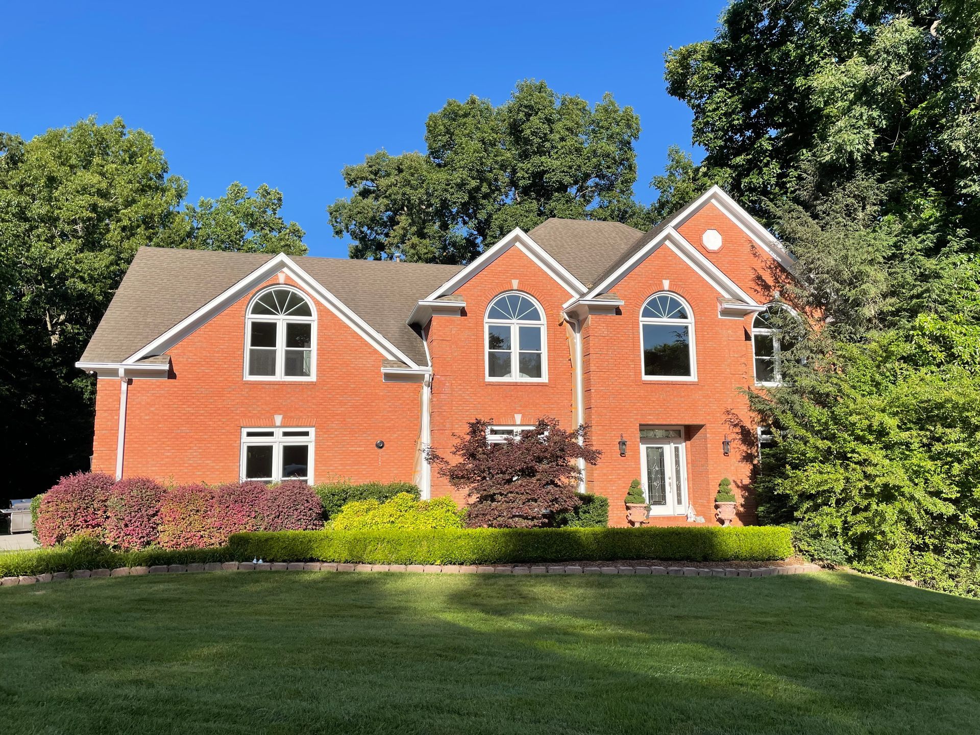 A large red brick house with a lot of windows