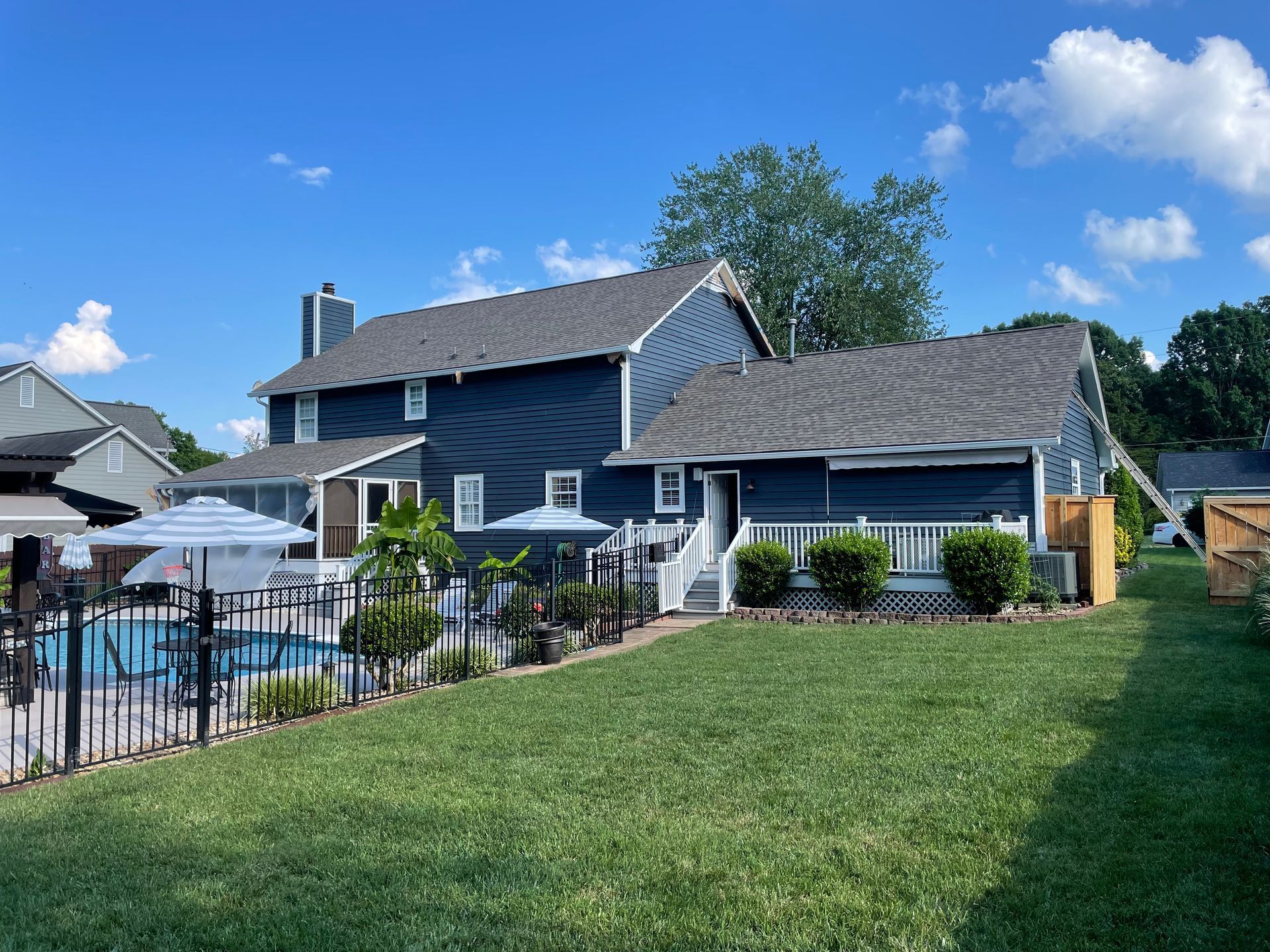 A large house with a swimming pool in the backyard.