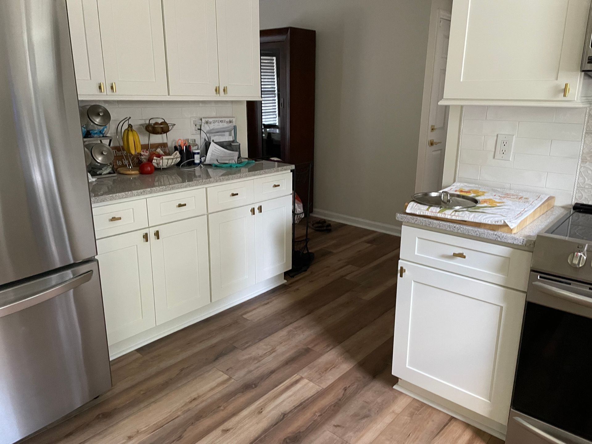 A kitchen with white cabinets and stainless steel appliances.