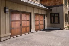 A house with two wooden garage doors and a window