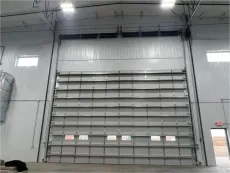 A large garage door is open in a building