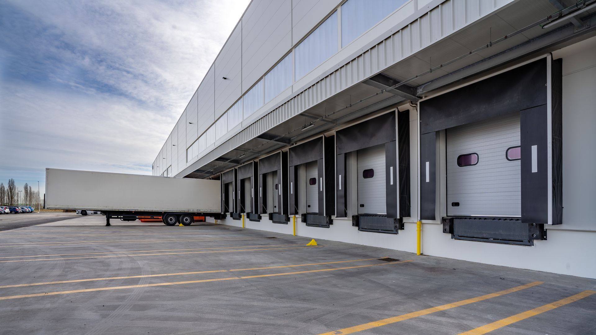 A truck is being loaded into a warehouse.