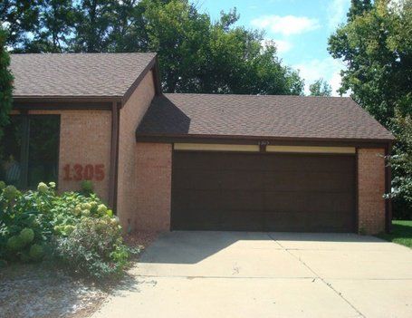 Brown garage and house with address