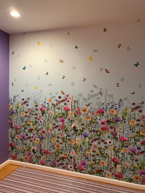 A wall with flowers and butterflies on it