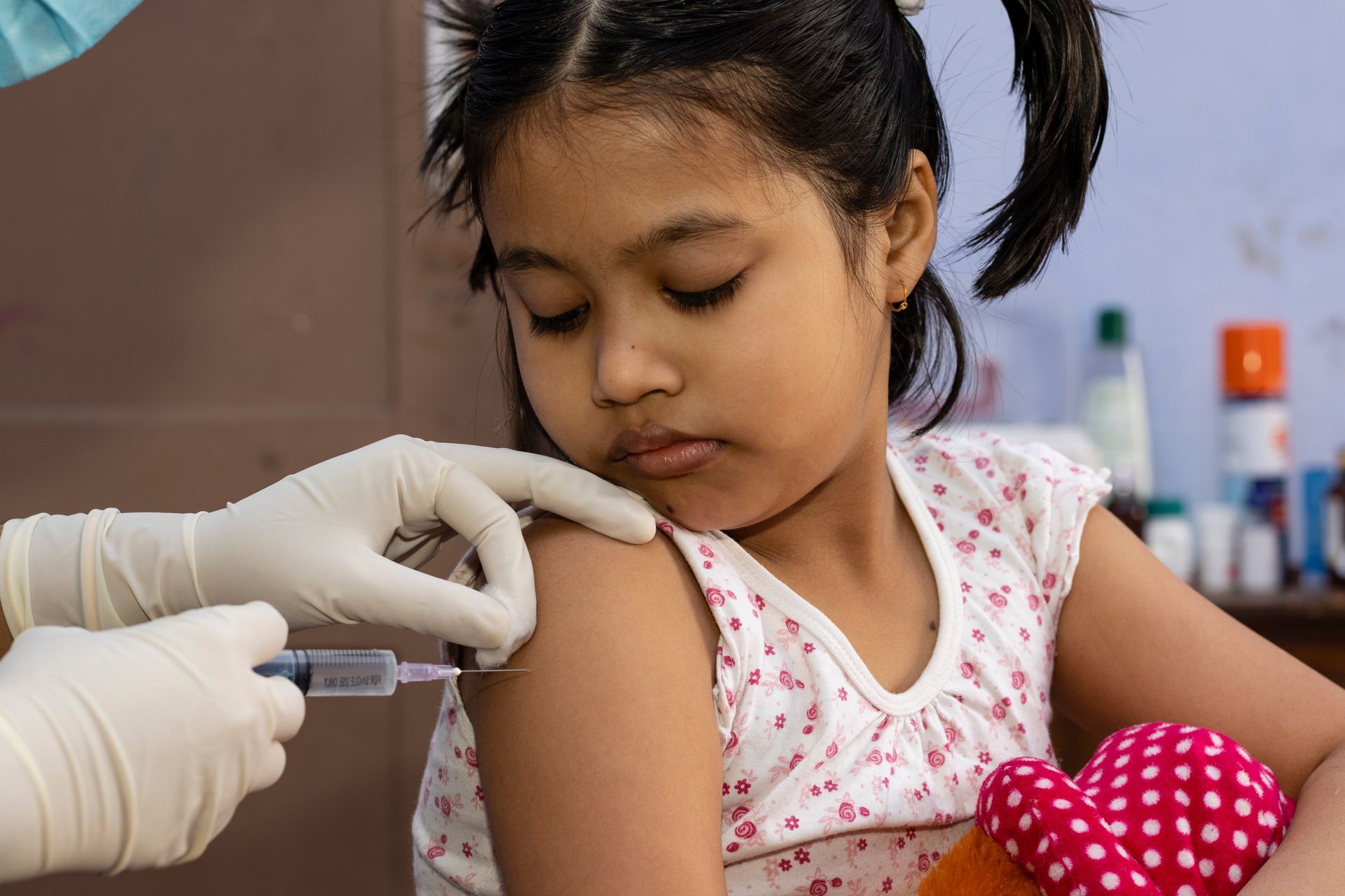 Healthcare professional administering a vaccine injection into an arm using a syringe. Healthcare professional administering a vaccine injection into an arm using a syringe.