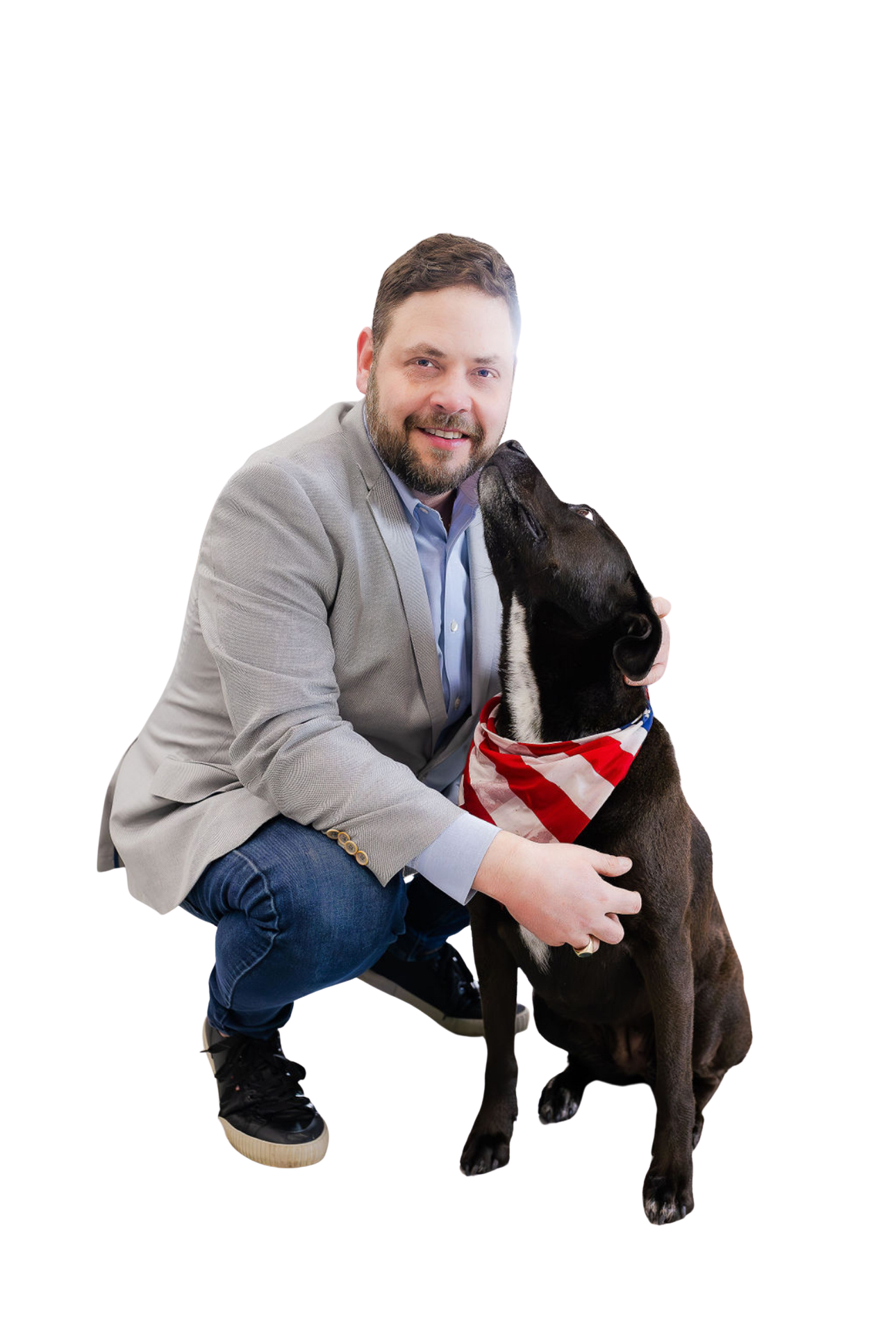 Woman in a navy blazer smiles at the camera, arms crossed. Indoors, blurred office background.