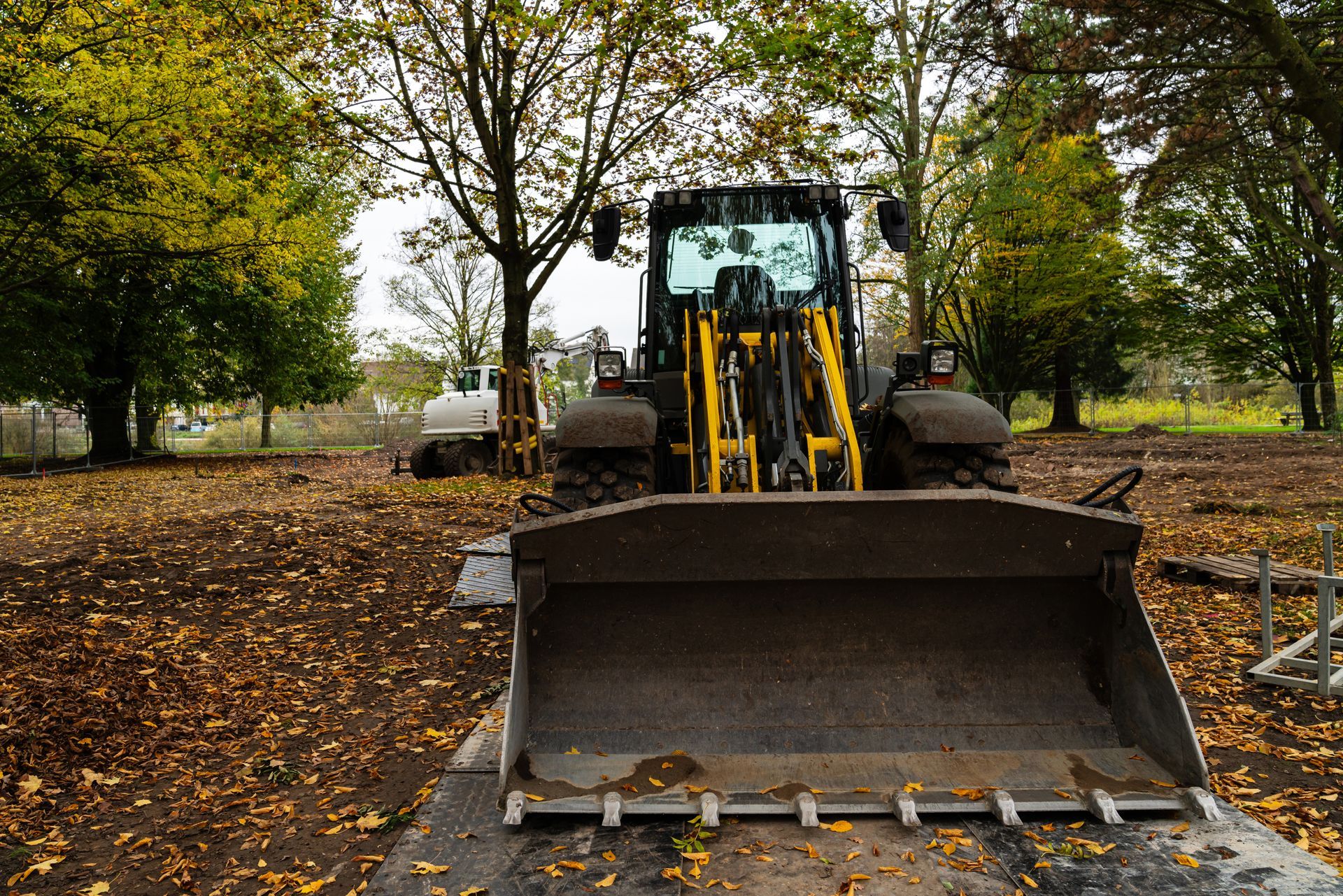 Front loader machine with a large bucket on a construction site.