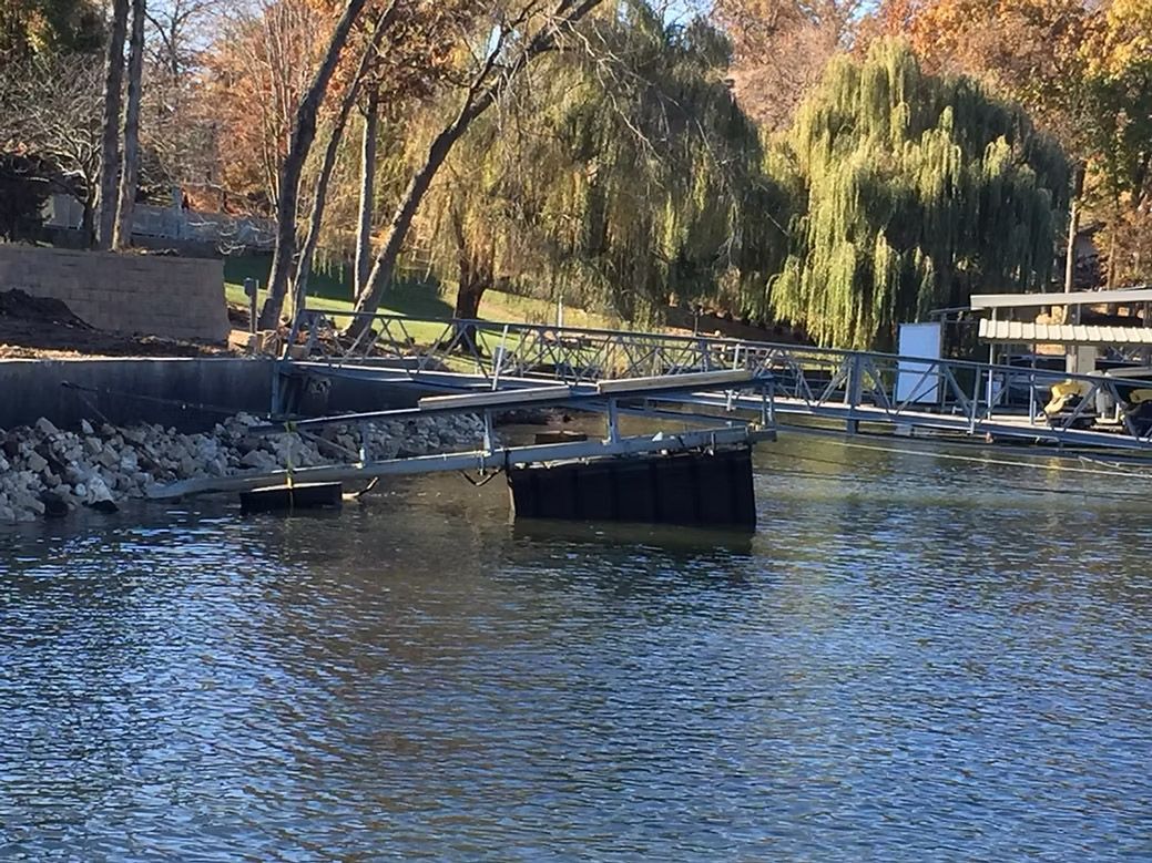 Water with structure and trees in background.
