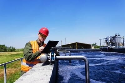 worker inspecting water worker inspecting water