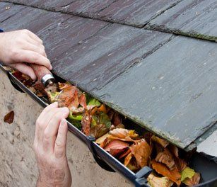 roof gutter being cleaned
