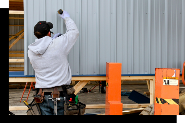 A man installing siding.