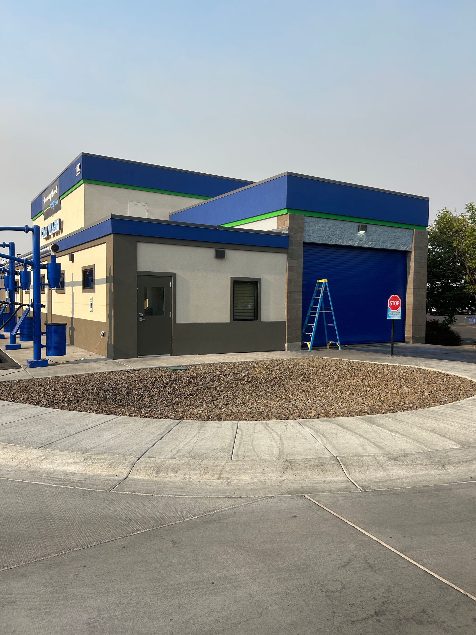 A blue and white building with a ladder in front of it