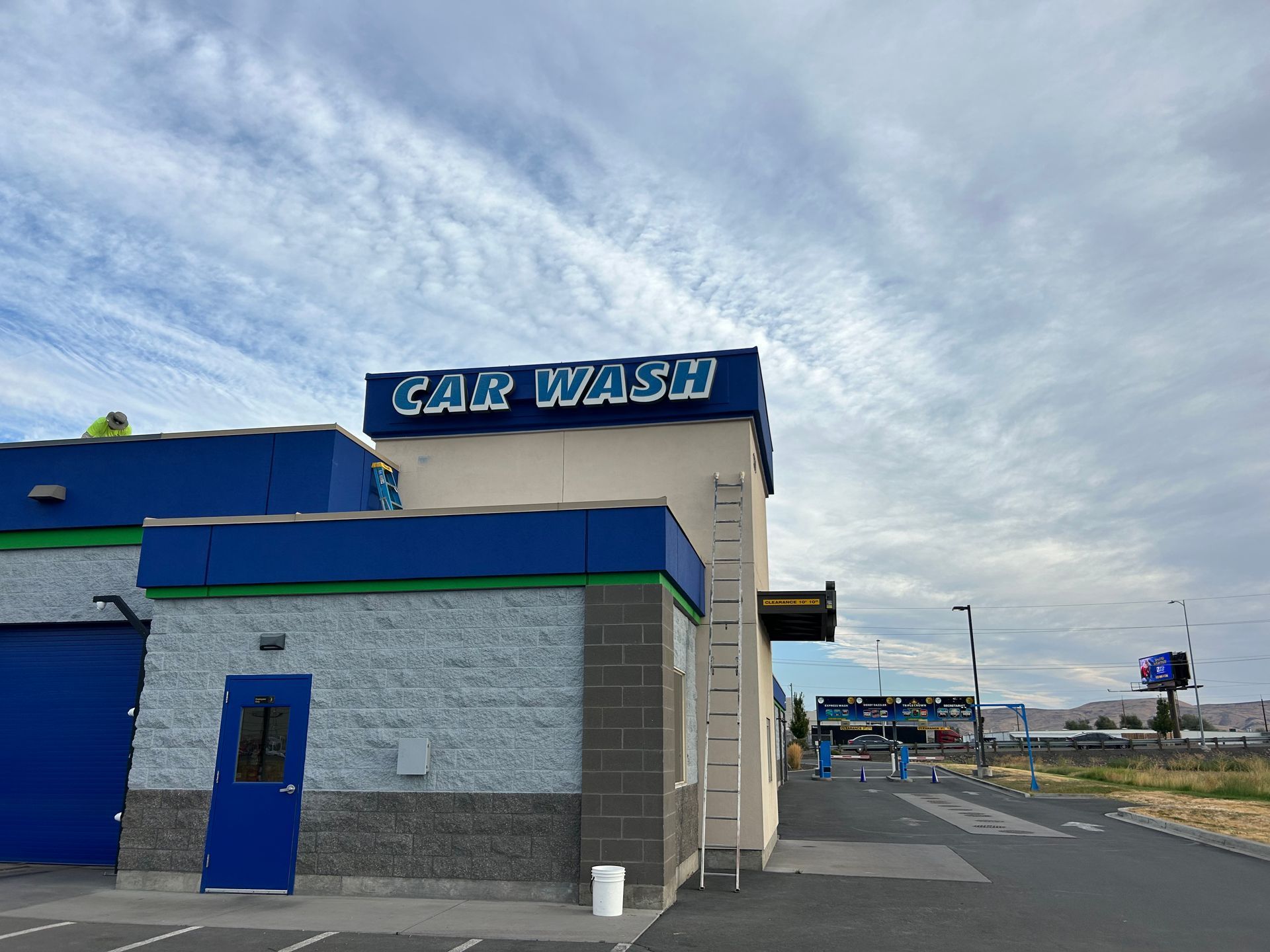 A car wash with a ladder on the side of it