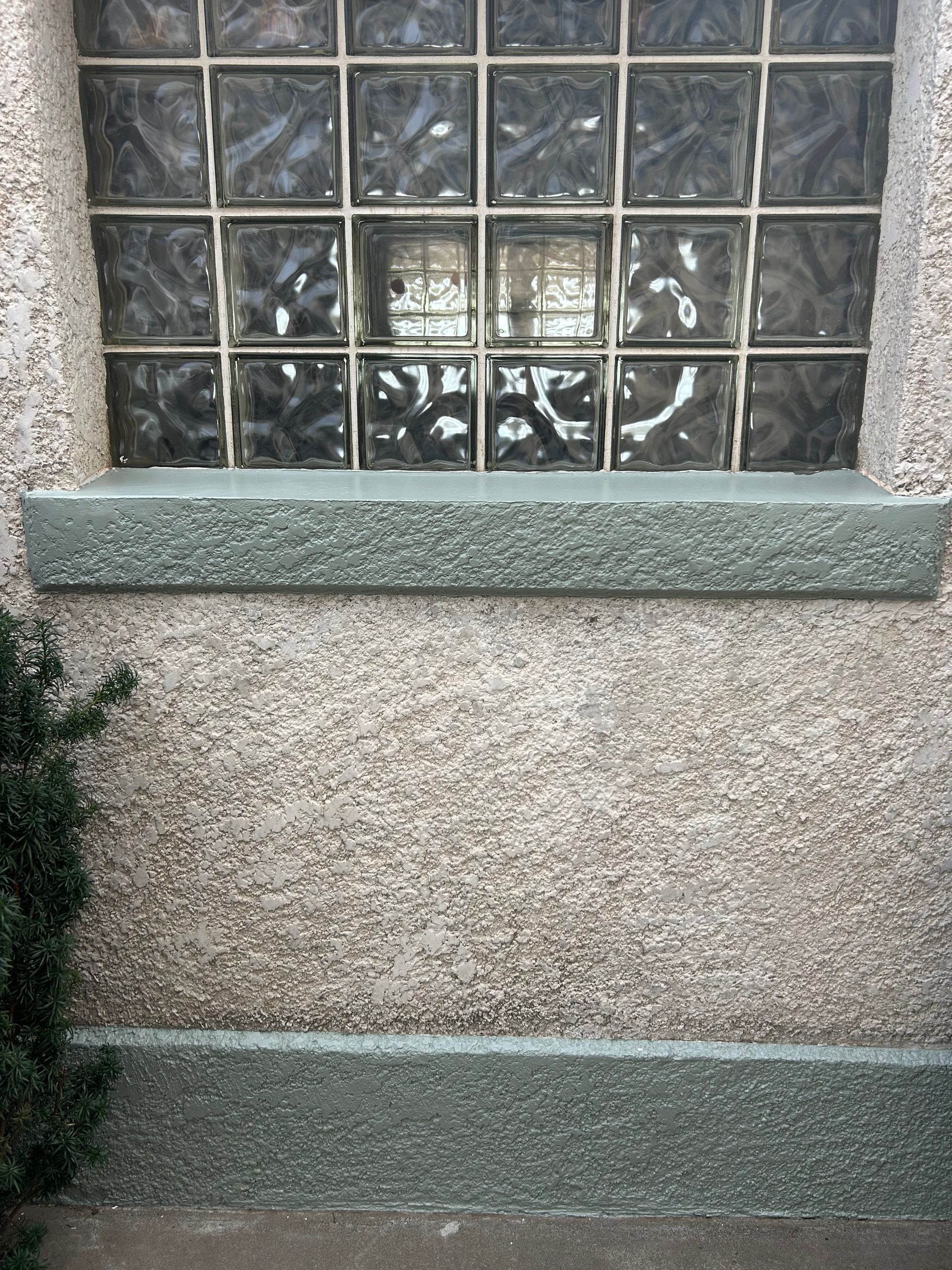 A window with glass blocks on the side of a building