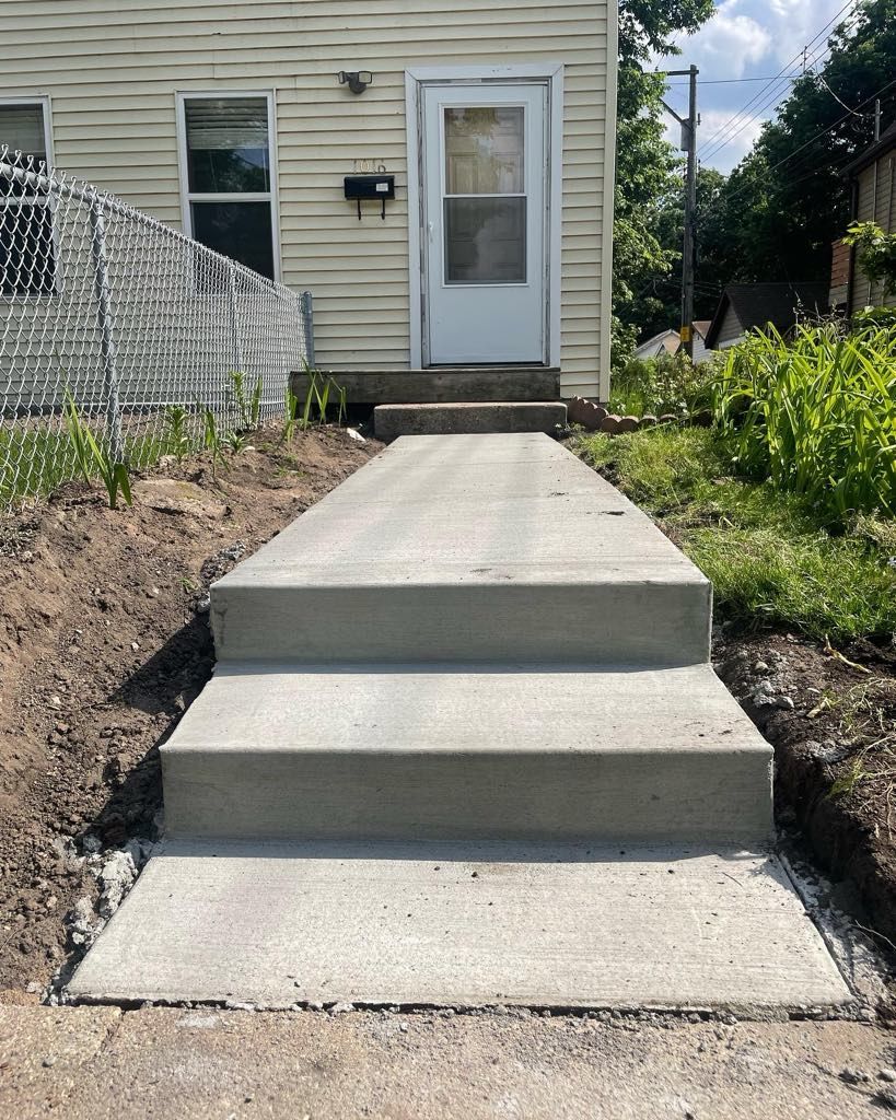 A set of concrete steps leading up to a house.
