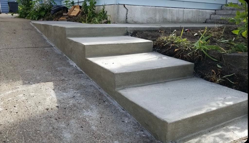 A set of concrete steps leading up to a house