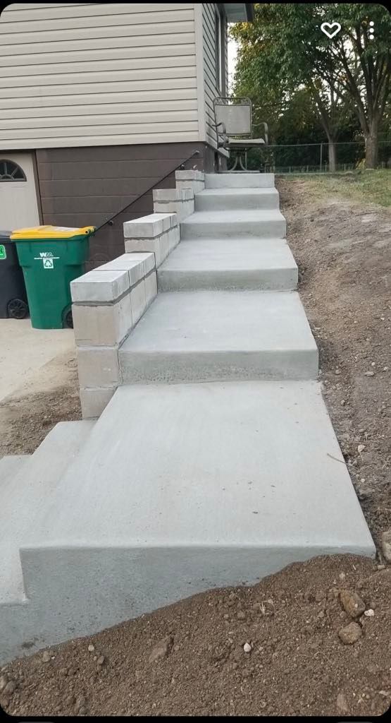 A set of concrete steps leading up to a house.